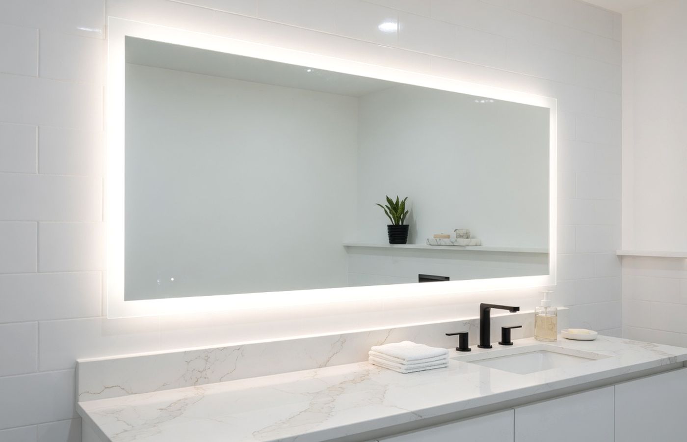 Bright bathroom with LED-lit vanity mirror