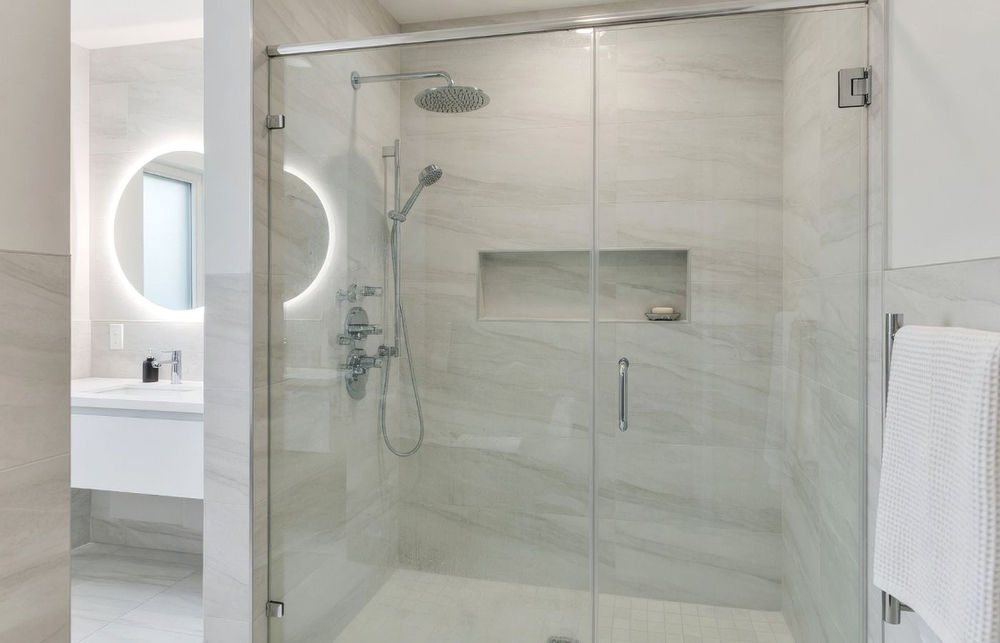 Frameless glass shower enclosure in a modern bathroom